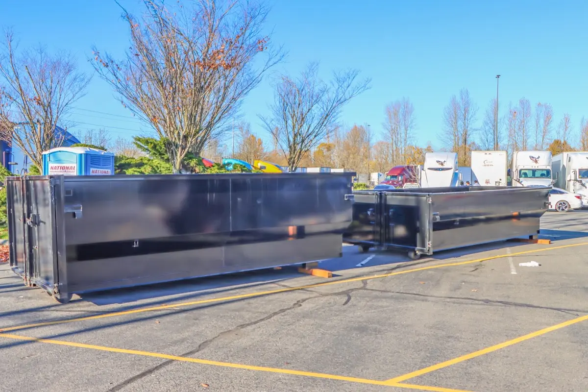 Professional dumpster rental service with roll-off container on residential driveway in Bonadelle Ranchos